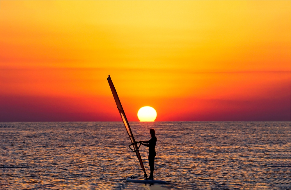 Windsurfing,At,Sunset,Horizon,View.,Windsirfer,Girl,At,Sunset.,Sunset