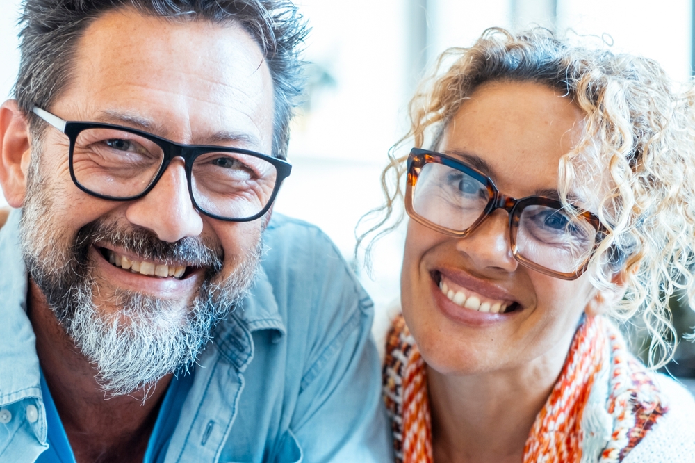An,Adult,Couple,In,Their,Late,40s,,Wearing,Glasses,,Smiling